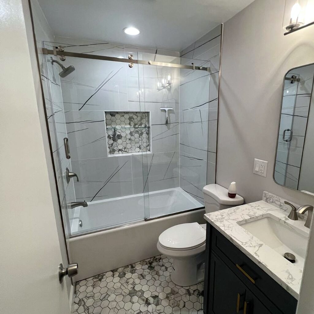 Bathroom remodel: Glass tub enclosure, mosaic niche and navy vanity