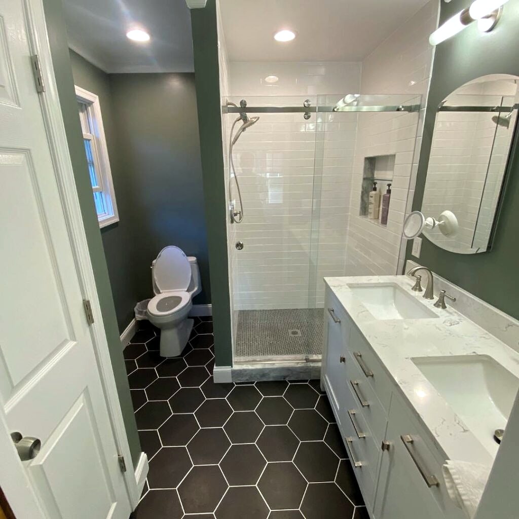 Bathroom remodel: Glass walk-in shower and black hexagon floor tile