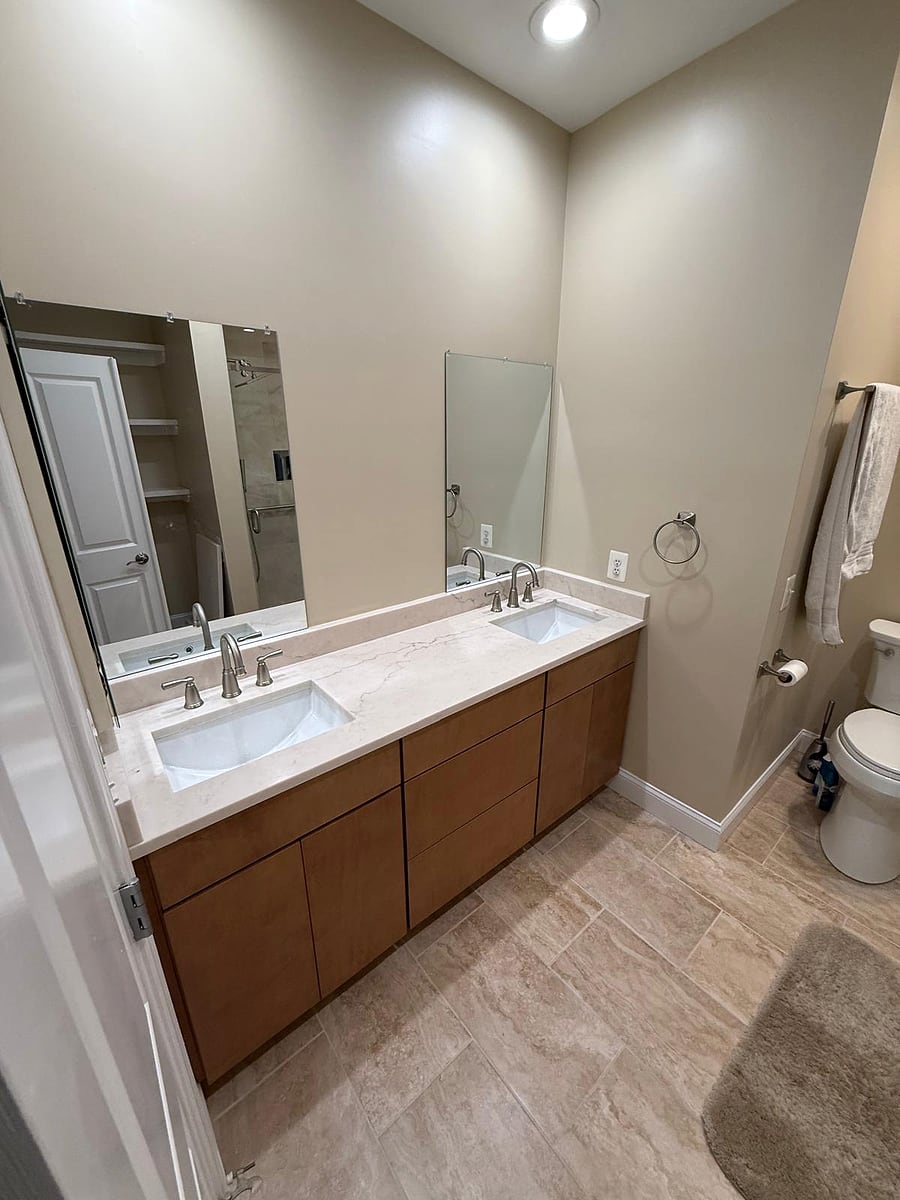 After: New double vanity, stone top and tile floor