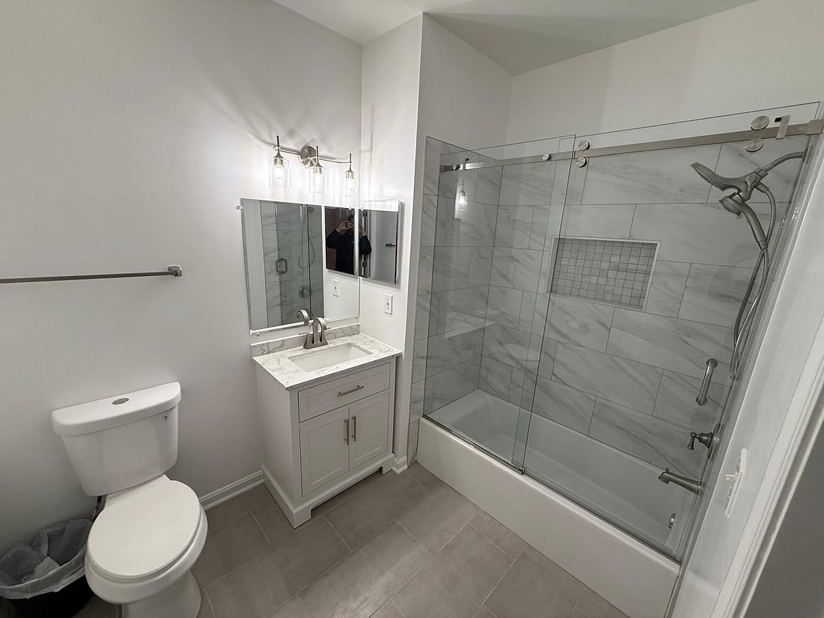 Bathroom remodel: Marble-look tub surround and sliding glass door