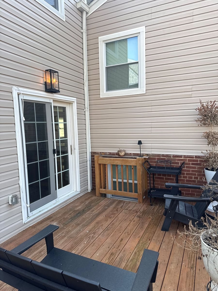 After: The finished back deck with new siding, trim and lighting