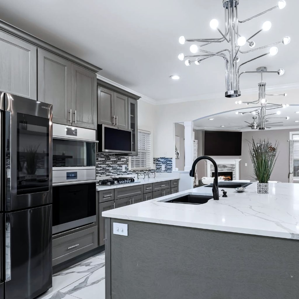 Kitchen remodel: Gray shaker cabinets, a large island and a modern chandelier