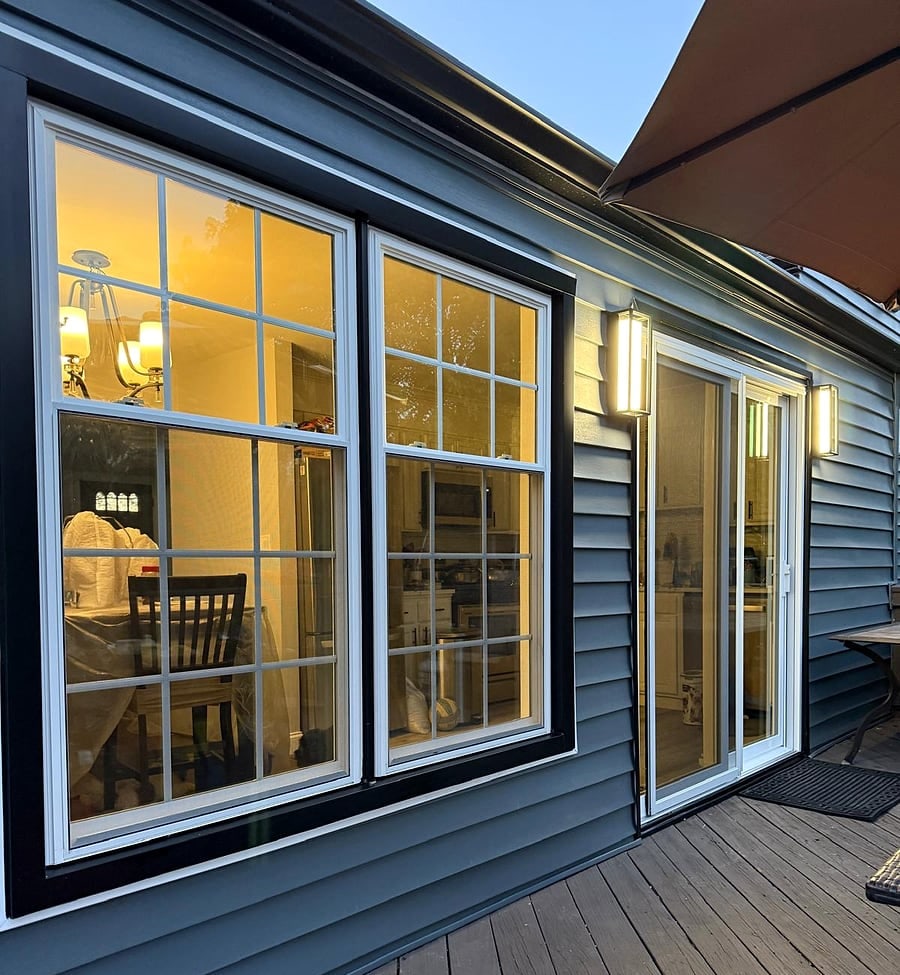 Siding & windows: New navy siding, black window trim and wall lights